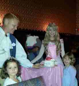 The birthday girl with her Aurora themed cake (allergy-free recipe, get to pick your princess, balloon, card signed by the princesses and mini tiara for $85 + tax). At Cinderella's Royal Table. Fun to have Aurora visit when cake was presented. Also, this server, Ray, was amazing. Best server we had at Disney and honestly one of the best I've had ever. Give him a raise!!