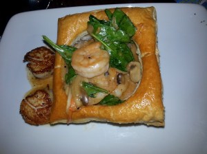 The signature shrimp and scallop entree at Be Our Guest. Fresh shellfish, rich sauce, a successful dinner. The pastry however could have been lighter and flakier.