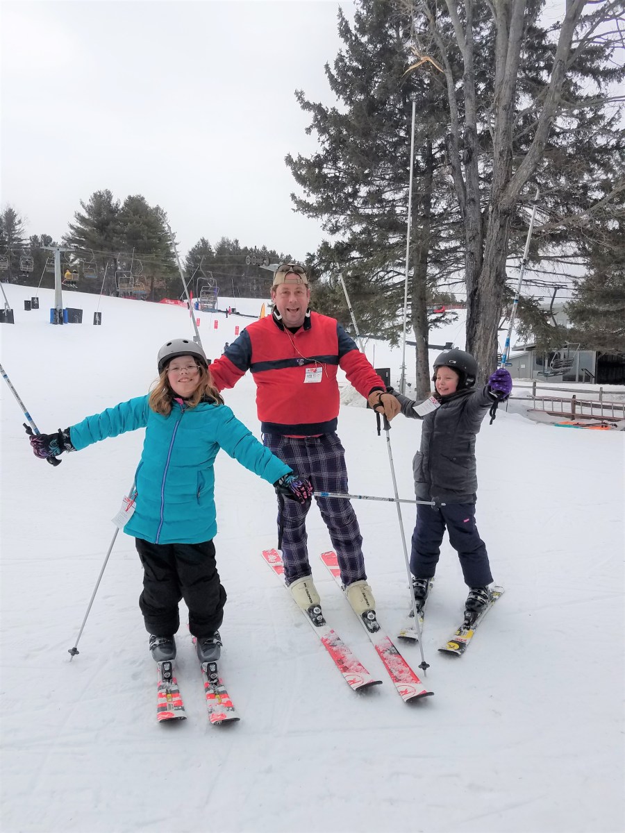 Kids and husband at the bottom of the bunny slope