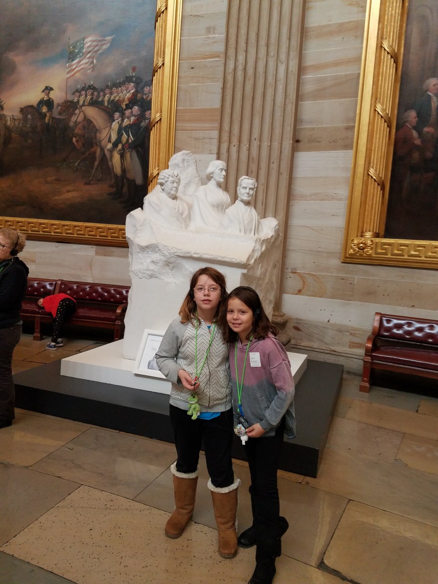 My daughters in the Capitol Building rotunda with Portrait Monument depicting Susan B. Anthony, Lucretia Mott, and Elizabeth Cady Stanton, sculpted by Adelaide Johnson in 1921.
