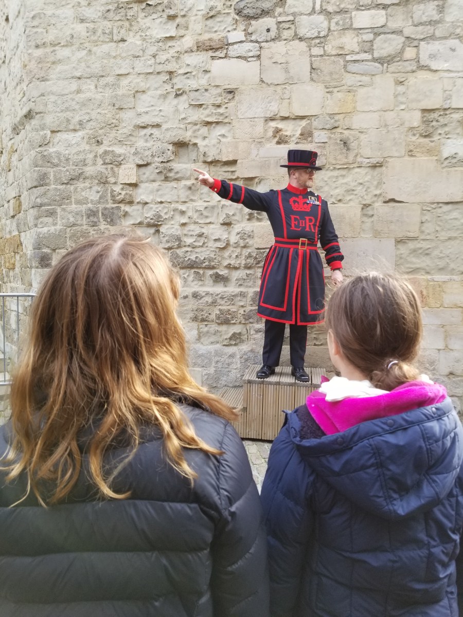 Children listening to a Beefeater on a Tower of London tour. Photo by Anastasia Mills Healy.